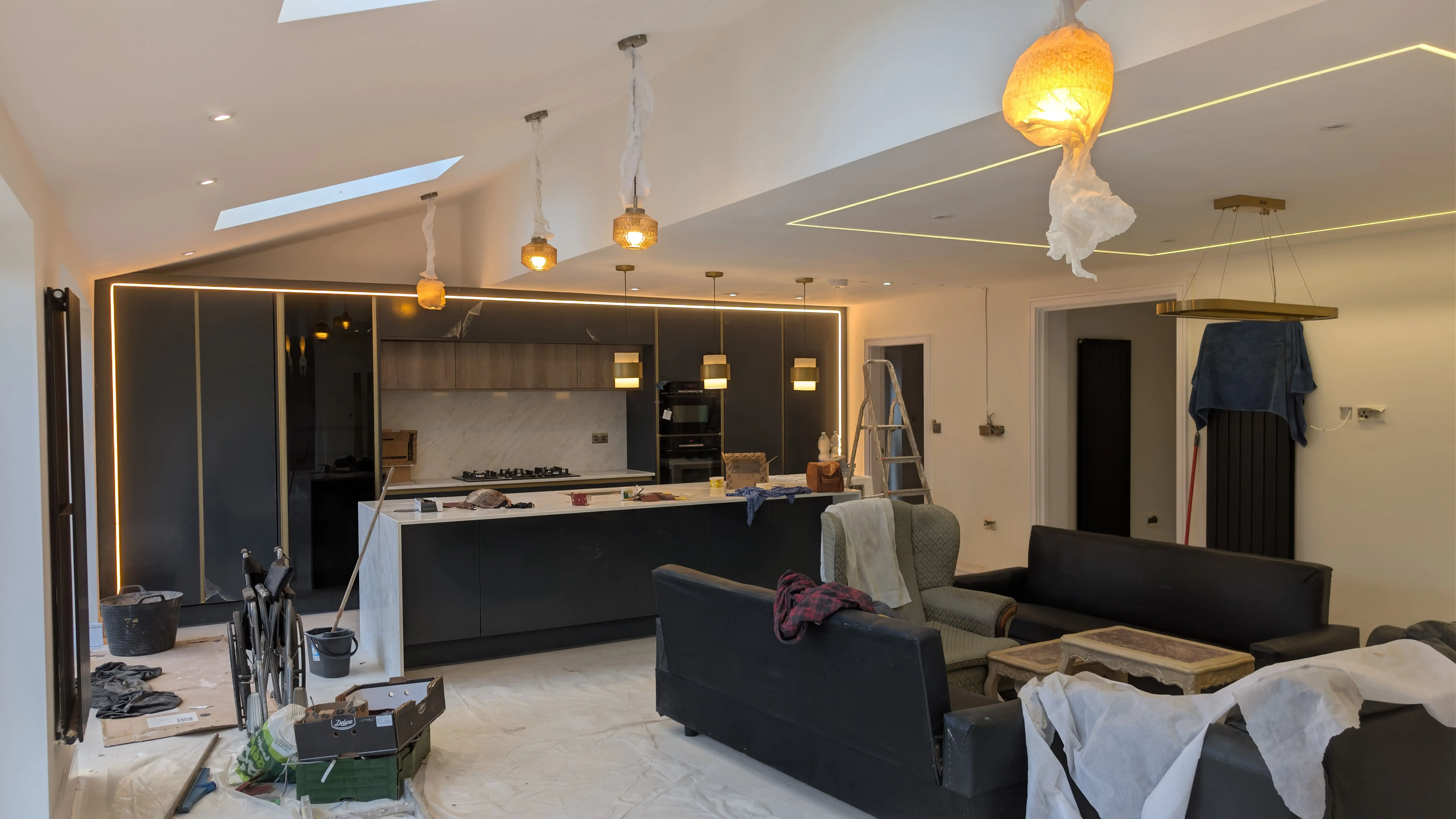 Dark, artist-led living room interior with bespoke sculpture and paneling by Extreme Ukay